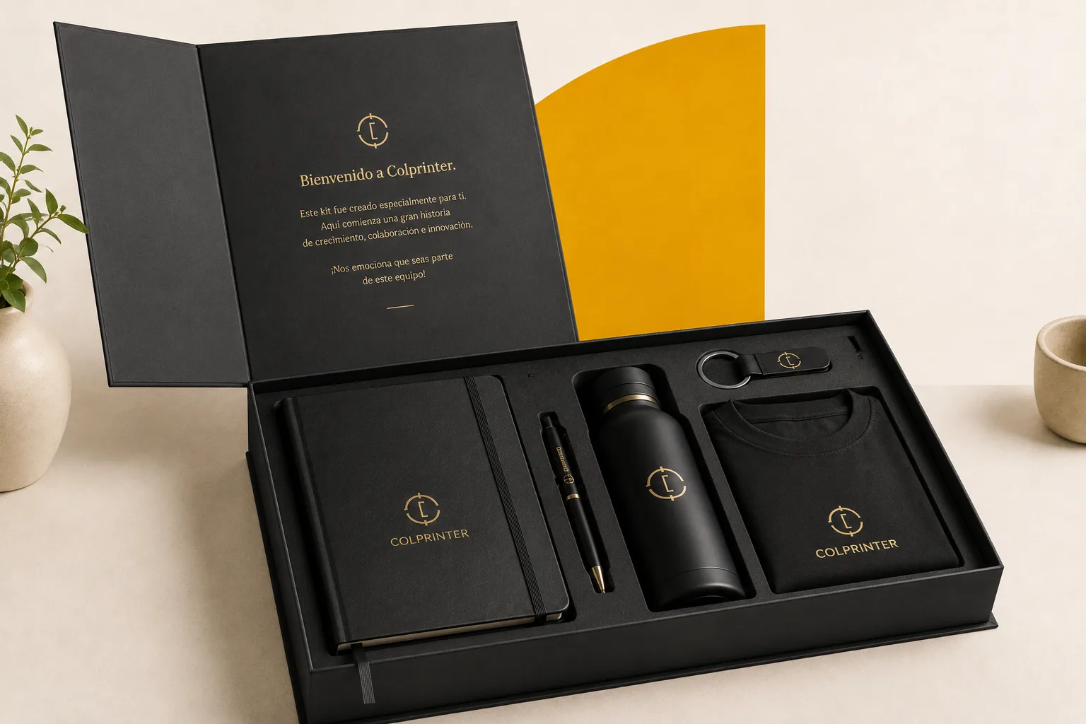 kit de bienvenida corporativo — caja tipo libro abierta con libreta ejecutiva, esfero y botilito personalizados Colprinter